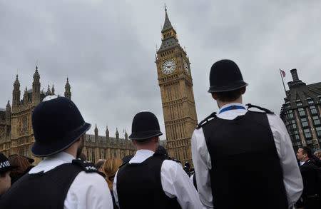 Police officers pay their respects during an event to mark one week since a man drove his car into pedestrians on Westminster Bridge then stabbed a police officer in London, Britain March 29, 2017. REUTERS/Hannah McKay