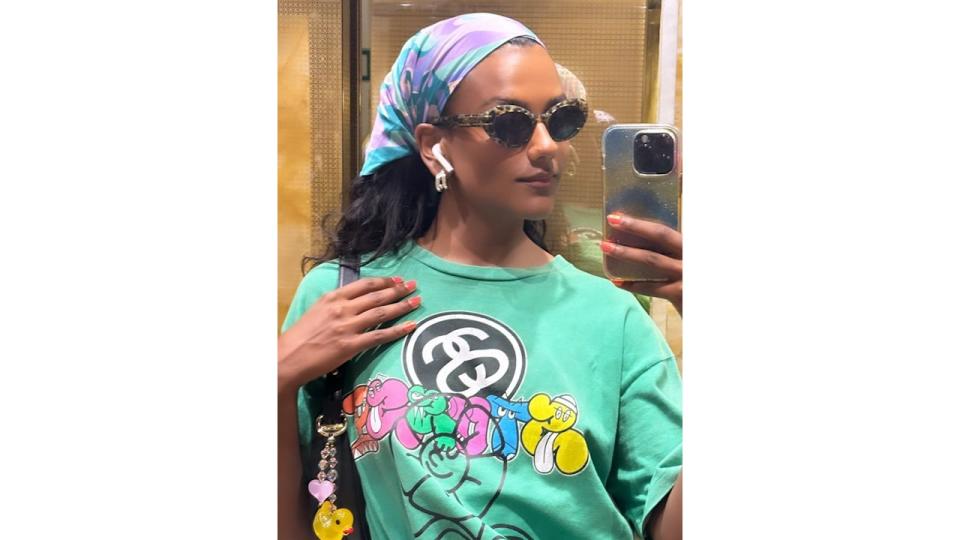 Simone Ashley posts a photo to her Instagram story wearing a green t-short and head scarf 