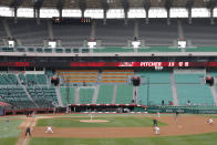 FILE - In this May 5, 2020, file photo, with empty stadium seats, the Hanwha Eagles and the SK Wyverns play during their baseball game in Incheon, South Korea. The baseball league is on. As South Korea significantly relaxes its rigid social distancing rules as a result of waning coronavirus cases, the world is paying close attention to whether it can return to something that resembles normal or face a virus resurgence. (AP Photo/Lee Jin-man, File)