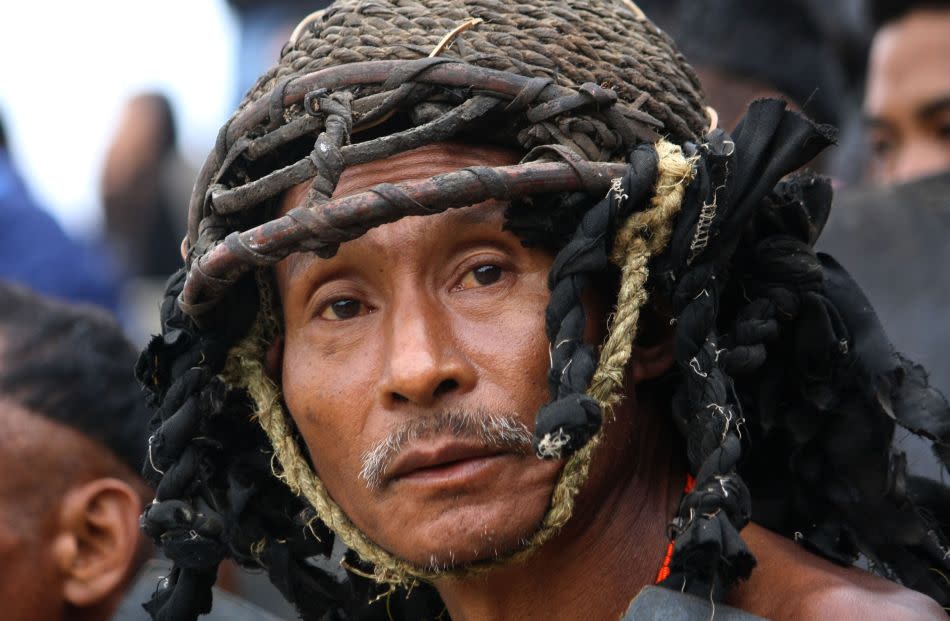 A Naga tribesman from Khiamniungan tribe with warrior headgear looks on as he waits to perform the ‘war between neighbours’ ritual.