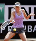 Maria Sharapova of Russia hits a return to Ana Ivanovic of Serbia during their women's singles match at the Rome Masters tennis tournament May 15, 2014. REUTERS/Max Rossi (ITALY - Tags: SPORT TENNIS)
