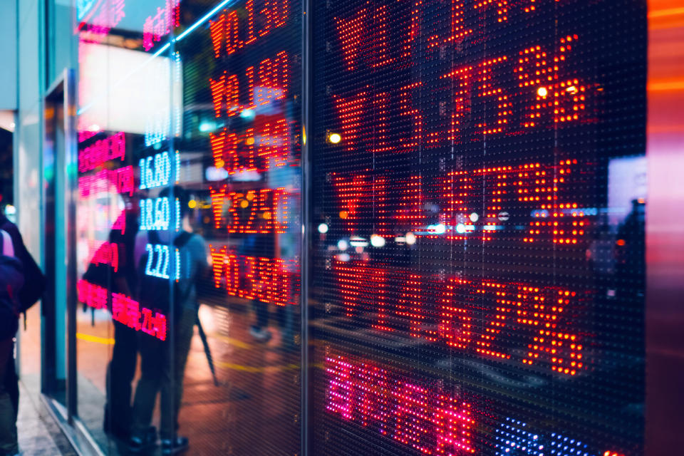 Stock exchange market display screen board on the street showing stock market crash sell-off in red colour