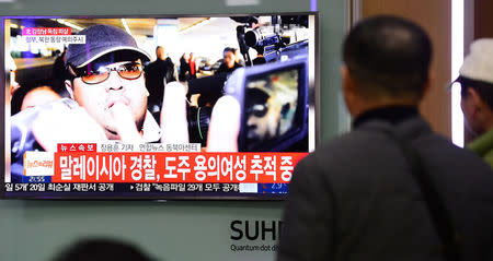 People watch a TV screen broadcasting a news report on the assassination of Kim Jong Nam, the older half brother of the North Korean leader Kim Jong Un, at a railway station in Seoul, South Korea, February 14, 2017. Lim Se-young/News1 via REUTERS