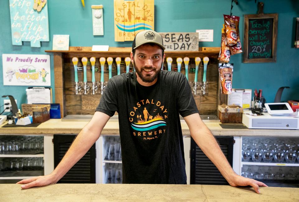 Alex Tatko, the new owner of Coastal Dayz Brewery in Fort Myers, is shown behind the bar on Tuesday, March 28, 2023.