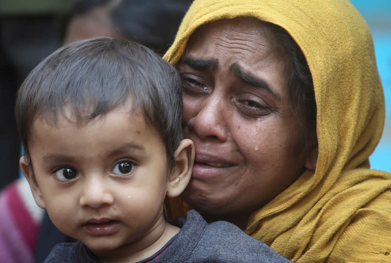 FILE PHOTO: A Rohingya Muslim woman cries as she holds her daughter after they were detained by Border Security Force (BSF) soldiers while crossing the India-Bangladesh border from Bangladesh, at Raimura village on the outskirts of Agartala