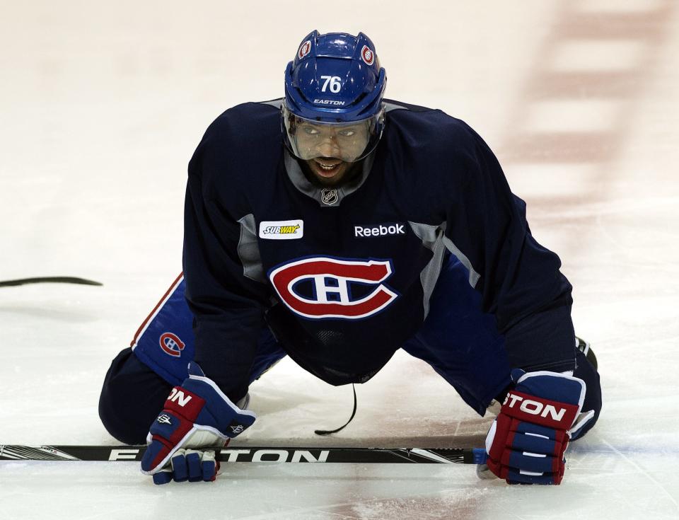 Montreal Canadiens defenseman P.K. Subban stretches during NHL hockey practice Tuesday, Jan. 7, 2014, in Brossard, Quebec. Subban was named to Canada's Olympic hockey team on Tuesday. (AP Photo/The Canadian Press, Ryan Remiorz)