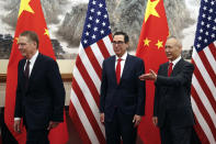 Chinese Vice Premier Liu He, right, shows the way to U.S. Treasury Secretary Steven Mnuchin, center, and U.S. Trade Representative Robert Lighthizer, left, as they proceed to their meeting at the Diaoyutai State Guesthouse in Beijing, Wednesday, May 1, 2019. (AP Photo/Andy Wong, Pool)