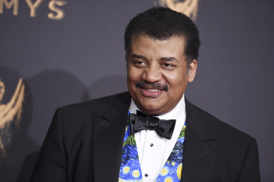 FILE- In this Sept. 9, 2017 file photo, Neil Degrasse Tyson arrives at night one of the Creative Arts Emmy Awards at the Microsoft Theater in Los Angeles. A museum spokesman said in a statement Thursday, July 25, 2019, the astrophysicist will keep his job as head of the Hayden Planetarium at New York's American Museum after the museum concluded its investigation into sexual misconduct charges against him. (Photo by Richard Shotwell/Invision/AP, File)