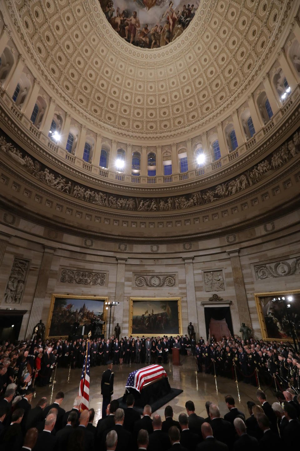 Bush's flag-draped casket lies in state inside the Capitol Rotunda.