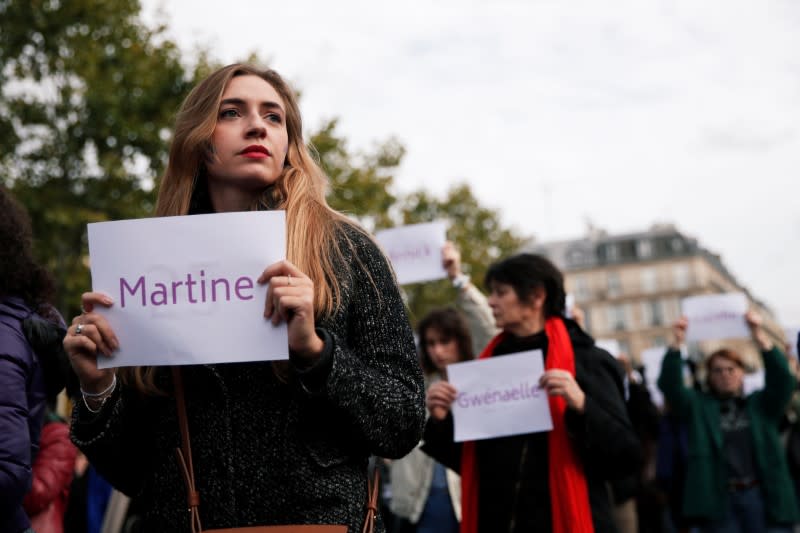 People attend a demonstration against femicide and violence against women at Place de la Republique in Paris