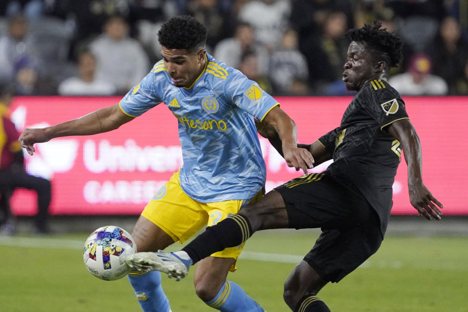Philadelphia Union defender Nathan Harriel, left, and Los Angeles FC forward Kwadwo Opoku battle for the ball during the first half of an MLS match Saturday, May 7, 2022, in Los Angeles. (AP Photo/Mark J. Terrill)