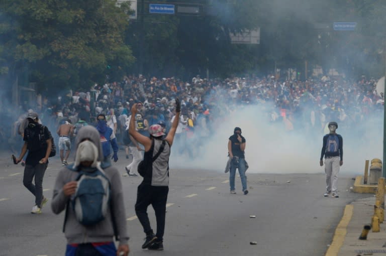 Venezuelan opposition activists clash with riot police in Caracas on April 10, 2017
