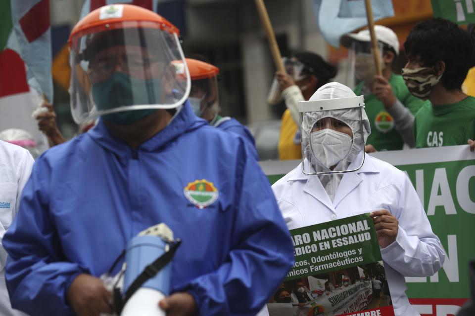 Health workers protest against the lack of protective equipment for those attending COVID-19 patients, outside a public hospital in Lima, Peru, Tuesday, Sept. 29, 2020. (AP Photo/Martin Mejia)