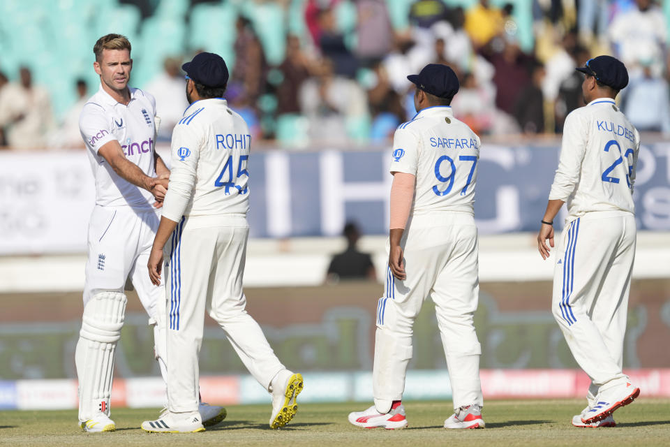 England's James Anderson, left, congratulates India's captain Rohit Sharma after India won the third cricket test match against England in Rajkot, India, Sunday, Feb. 18, 2024. (AP Photo/Ajit Solanki)