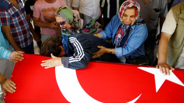 Relatives of a victim of Tuesday's attack mourn at her funeral.