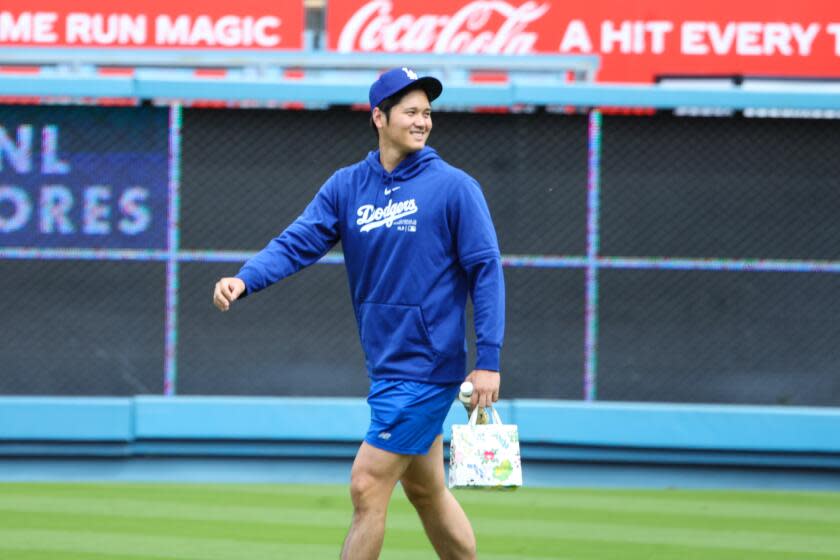 Los Angeles, CA - March 24: Shohei Ohtani greets former Angels team before the Los Angeles Dodgers.