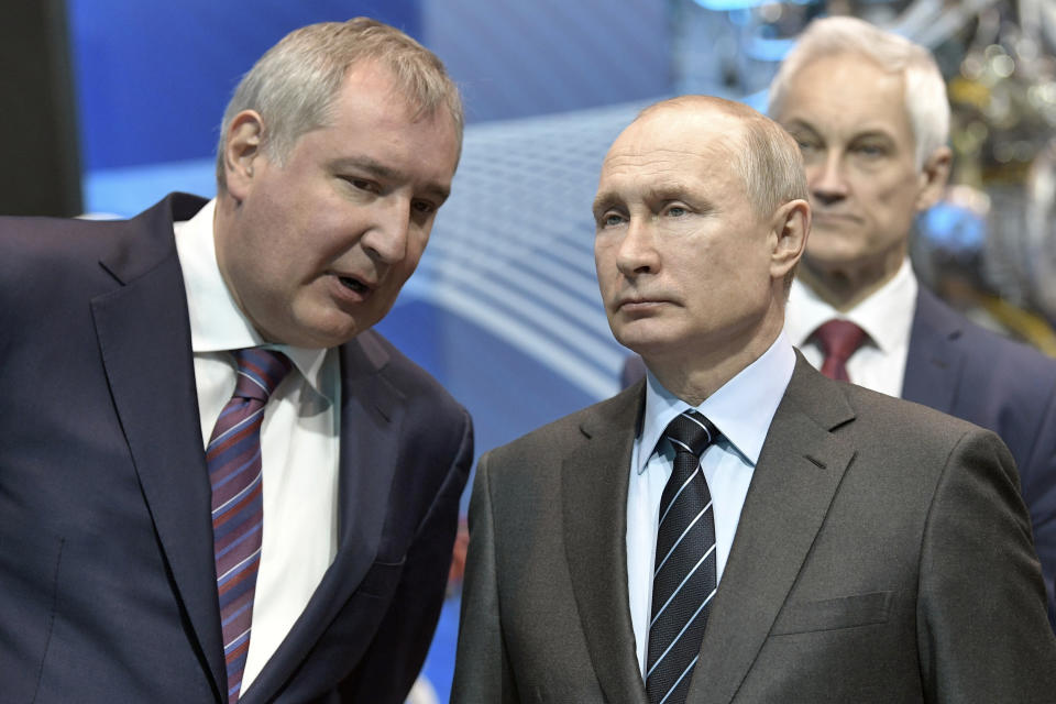 FILE - President Vladimir Putin, right, listens to Russian Roscosmos head Dmitry Rogozin as he visits the Energomash, leading Russian rocket engine company in Khimki, outside Moscow, Russia, Friday, April 12, 2019. Russian President Vladimir Putin on Friday removed Dmitry Rogozin as the head of state-controlled Roscosmos space agency that oversees the country's space program and includes rocket factories, launch facilities and numerous other assets. (Alexei Nikolsky, Sputnik, Kremlin Pool Photo via AP, File)