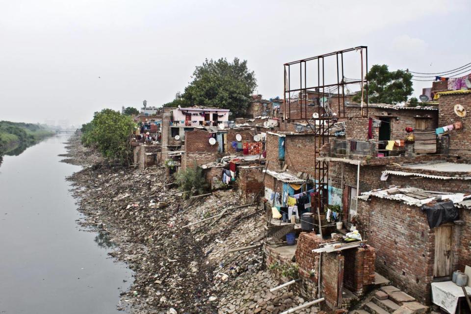 Modicare will cater to the poorest 40 per cent of Indians – eventually including those living in slums like this one, on the outskirts of Delhi. Here, there was little awareness of the incoming scheme (Adam Withnall/The Independent)