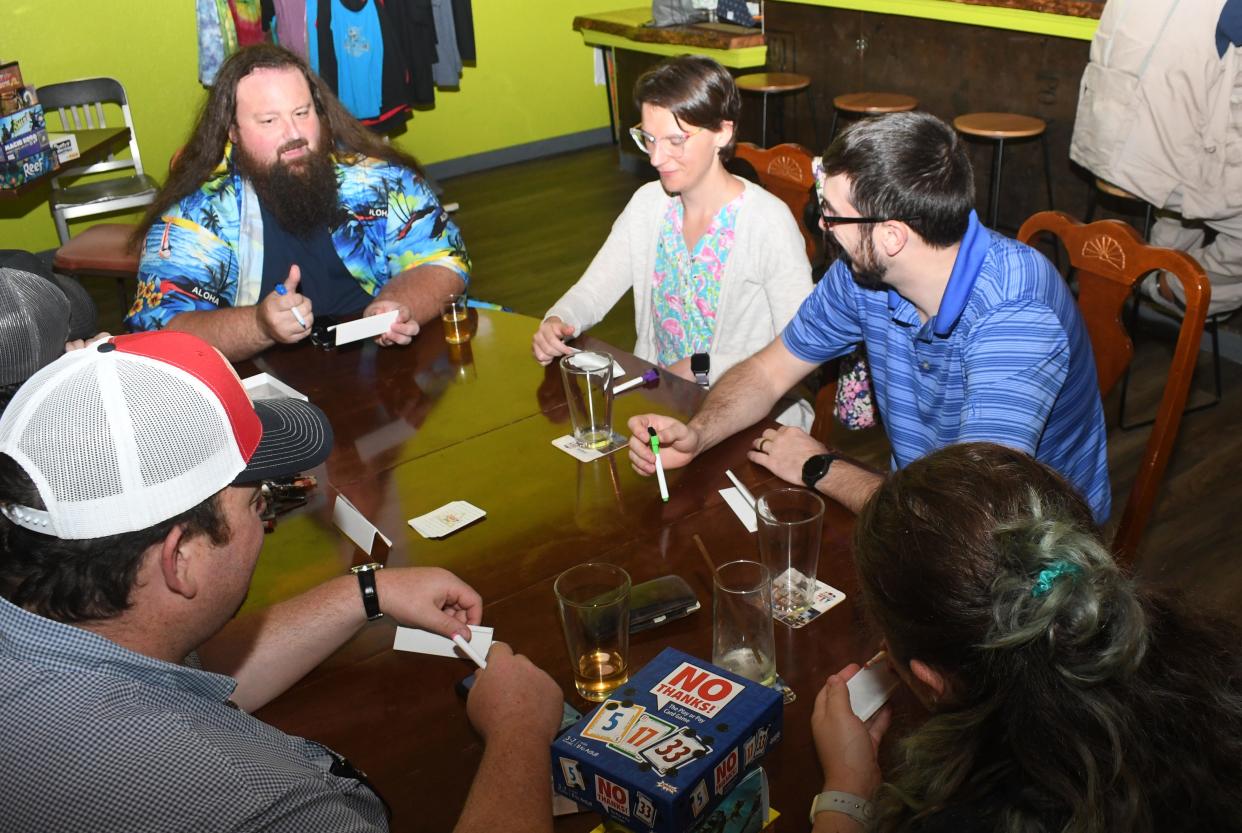 Central Louisiana Gamer’s Guild members Matt Gaspard (far left), Kaysie and Louis Busby, and Bliss and Jason Wise play hobby board games at Fighting Hand Brewing Company. The group plans to meet at the Pineville establishment once a month to not only play games but socialize.