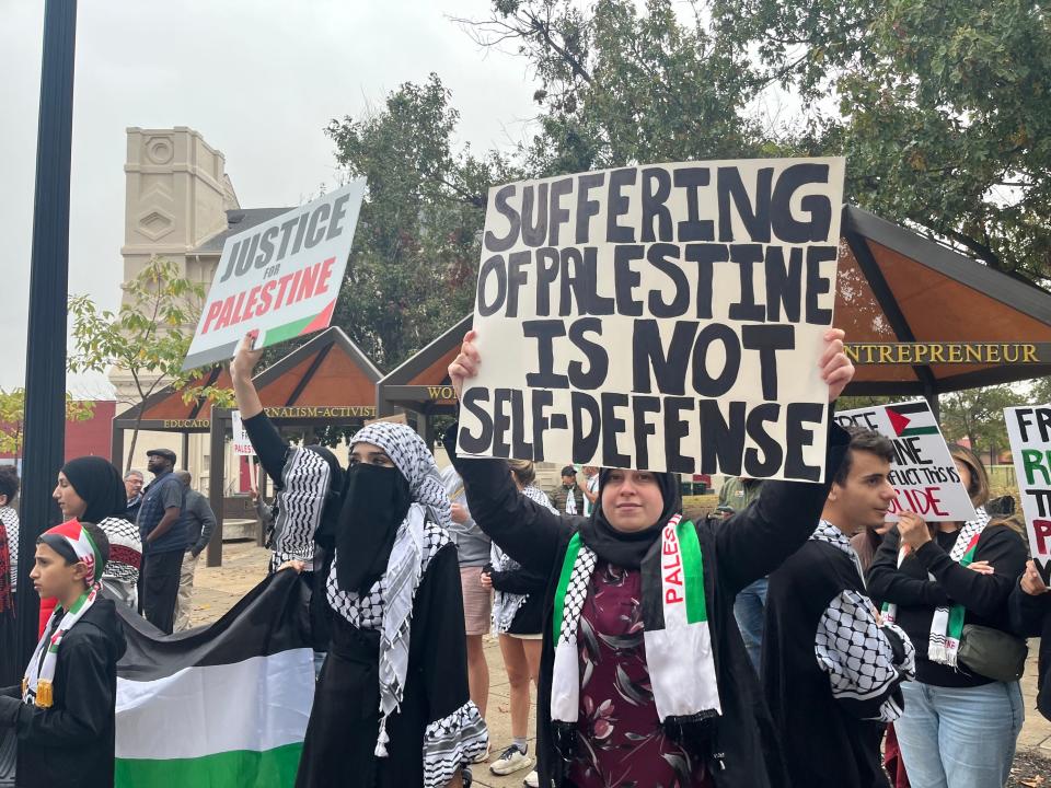 Women hold signs during a march in support of Palestine and those still trapped in Gaza on Sunday, Oct. 29, 2023, in Downtown Memphis.