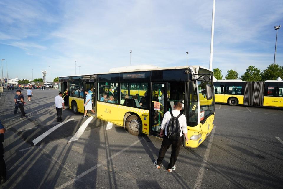 Man City fans on a shuttle bus as they head to Ataturk Olympic Stadium (PA)