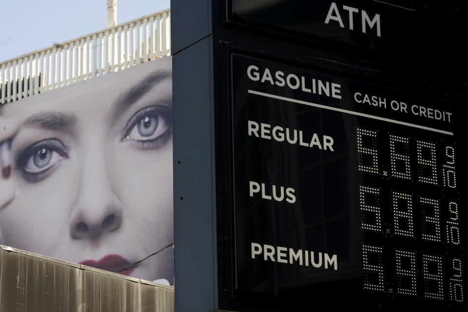 FILE - An advertisement for the series "The Dropout" is shown behind a price board at a gas station in San Francisco, on Tuesday, March 8, 2022. The average U.S. price of regular-grade gasoline shot up a whopping 79 cents over the past two weeks to $4.43 per gallon. Industry analyst Trilby Lundberg of the Lundberg Survey says Sunday, March 13, the new price exceeds by 32 cents the prior record high of $4.11 set in July 2008. Lundberg said gas prices are likely to remain high in the short term as crude oil costs soar amid global supply concerns following Russia's invasion of Ukraine. Nationwide, the highest average price for regular-grade is in the San Francisco Bay Area, at $5.79. (AP Photo/Jeff Chiu, File)