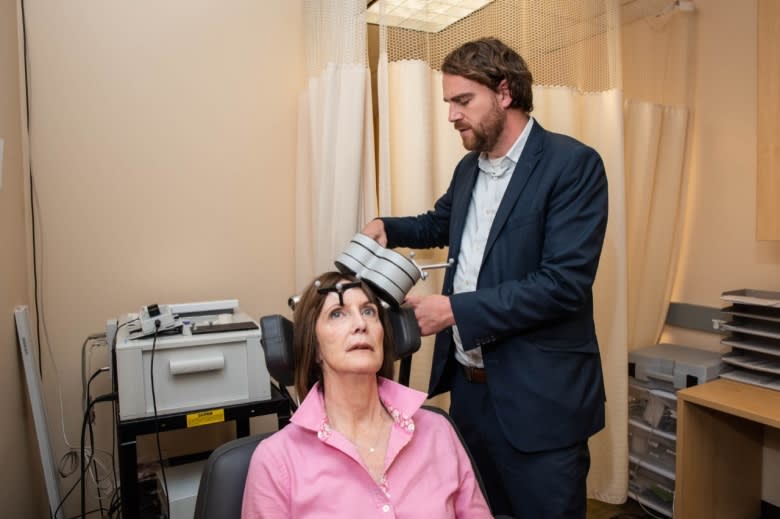 <div class="inline-image__caption"><p>Nolan Williams demonstrating the TMS system on Deirdre Lehman, who suffered from depression.</p></div> <div class="inline-image__credit">Steve Fisch/Stanford Med</div>