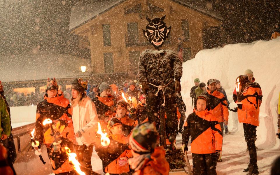 Race officials parade through the city with an effigy of the devil that would be burned at the stake to ward off bad luck