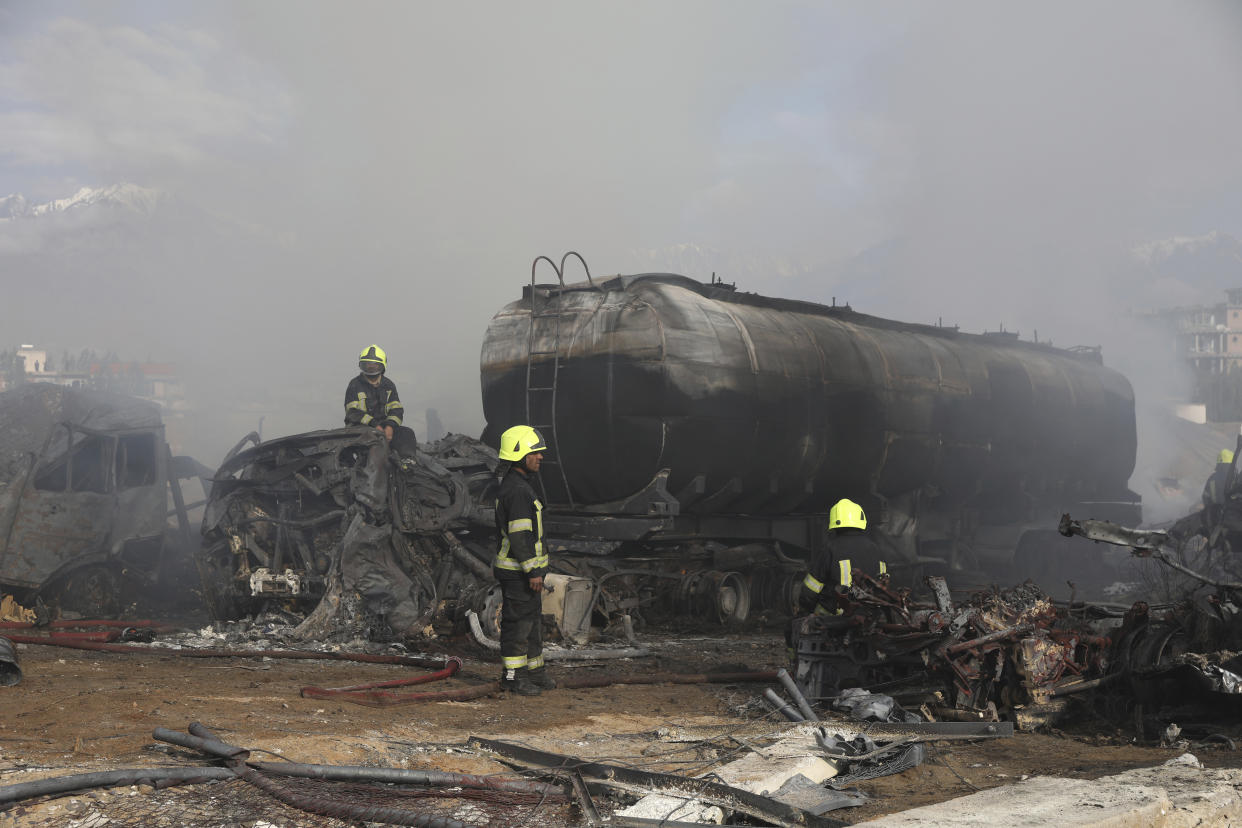 Firefighters work to extinguish a burning fuel tanker in Kabul, Afghanistan, Sunday, May 2, 2021. A fire roared through several fuel tankers on the northern edge of the Afghan capital late Saturday, injuring at least 10 people and plunging much of the city into darkness, officials said. (AP Photo/Rahmat Gul)