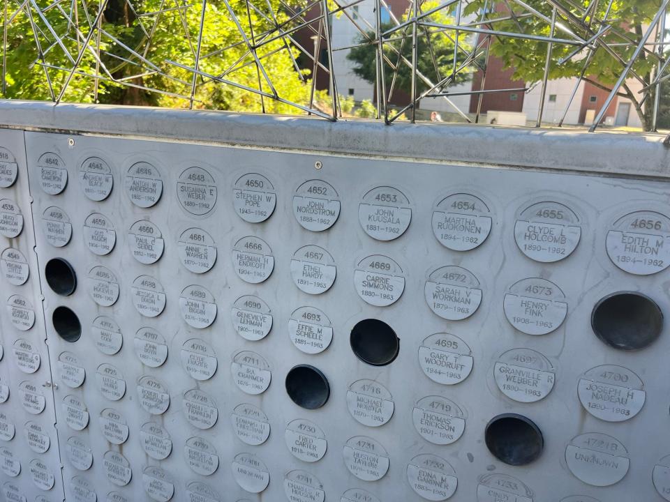 Each niche on the Oregon State Hospital Memorial wall has a circular plate engraved with a number, name and birthday and death years, if known. The empty holes signify cremains reunified with family members.