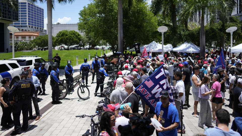 Supporters wait for the arrival of former President Donald Trump at the Wilkie D. Ferguson Jr. U.S. Courthouse, Tuesday, June 13, 2023, in Miami. Trump is making a federal court appearance on dozens of felony charges accusing him of illegally hoarding classified documents and thwarting the Justice Department's efforts to get the records back. (AP Photo/Rebecca Blackwell)