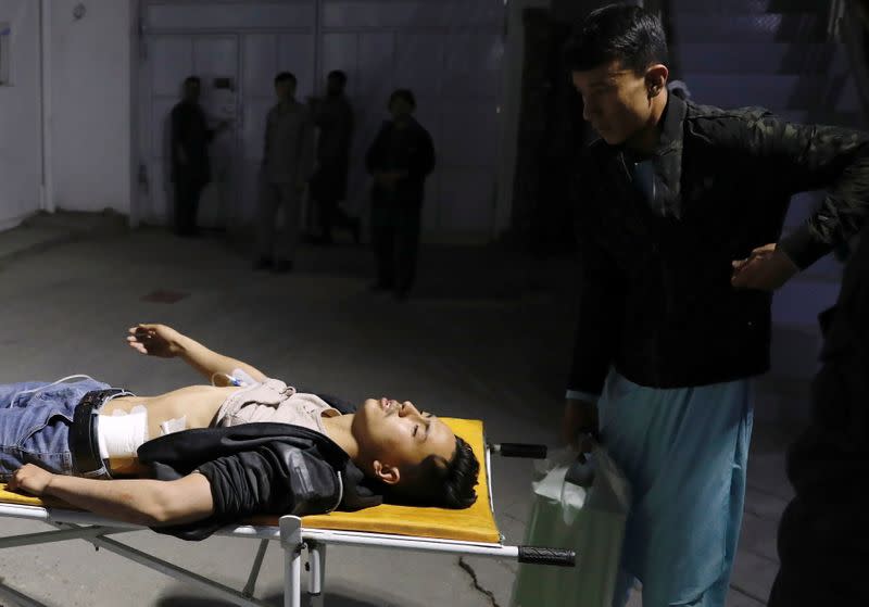 An injured man lies on a stretcher in a hospital after a suicide bombing in Kabul