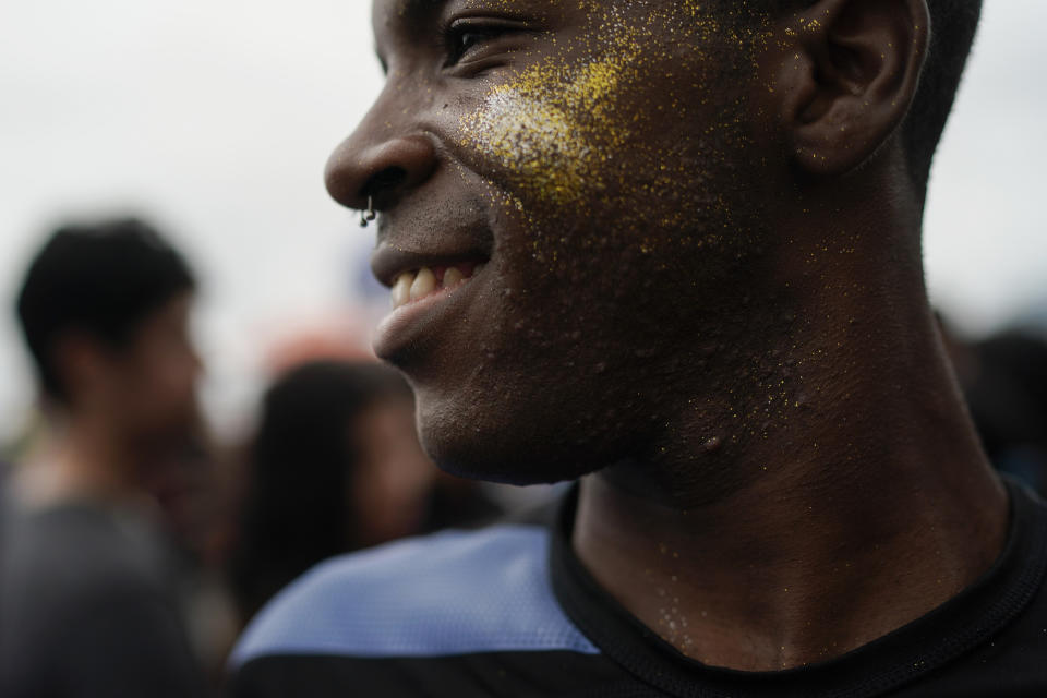 A man wearing glitter dances during the annual gay pride parade along Copacabana beach in Rio de Janeiro, Brazil, Sunday, Sept. 22, 2019. The 24th gay pride parade titled this year's parade: "For democracy, freedom and rights, yesterday, today and forever." (AP Photo/Leo Correa)