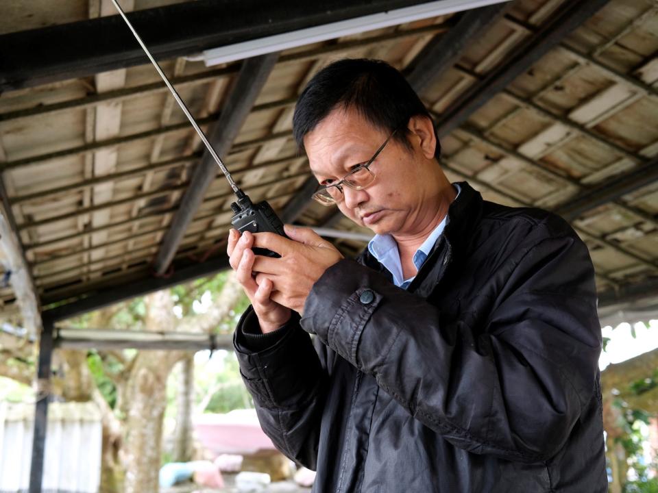 man looks at radio receiver