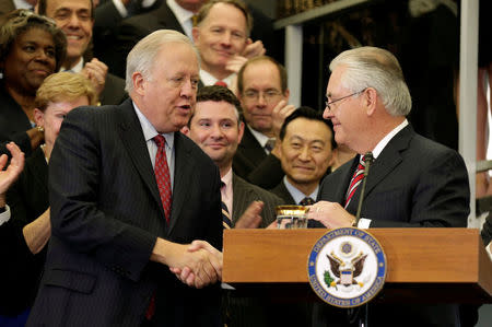 U.S. Secretary of State Rex Tillerson shakes hands with acting U.S. Secretary of State Tom Shannon while delivering remarks to Department of State employees upon arrival at the Department of State in Washington, U.S., February 2, 2017. REUTERS/Joshua Roberts