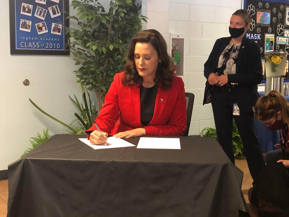 Gov. Gretchen Whitmer signs an executive order establishing a juvenile justice task force on June 9, 2021.