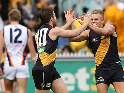 Reece Conca (L) of the Tigers celebrates a goal with Brandon Ellis during the round 12 AFL match between the Richmond Tigers and the Adelaide Crows at Melbourne Cricket Ground on June 15, 2013 in Melbourne, Australia.
