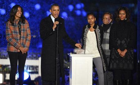 U.S. President Barack Obama prepares to throw the switch as he is joined by First Lady Michelle Obama (R), mother-in-law Marian Robinson (2nd R) and daughters Malia (L) and Sasha at the National Christmas Tree Lighting ceremony on the Ellipse in Washington, December 6, 2013. REUTERS/Mike Theiler