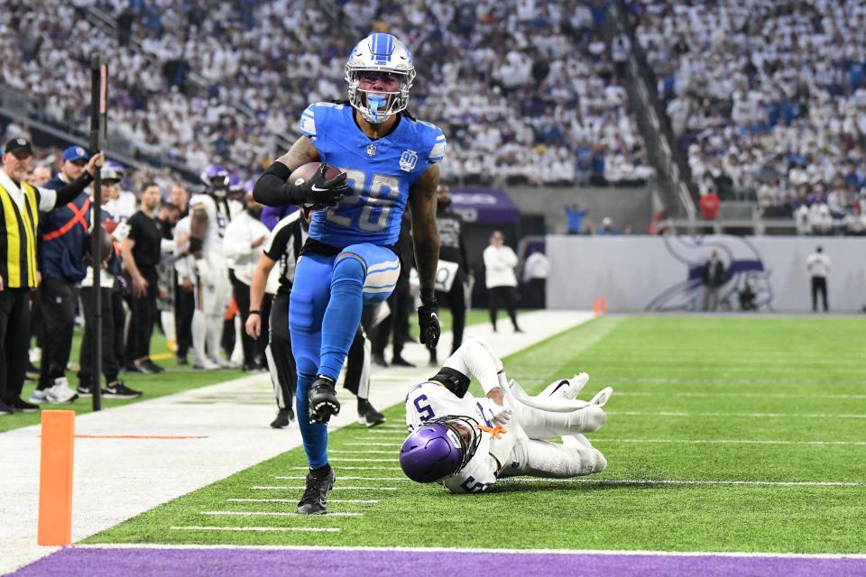 Lions running back Jahmyr Gibbs scores a rushing touchdown against Vikings defensive back Mekhi Blackmon during the second quarter on Sunday, Dec. 24, 2023, in Minneapolis.