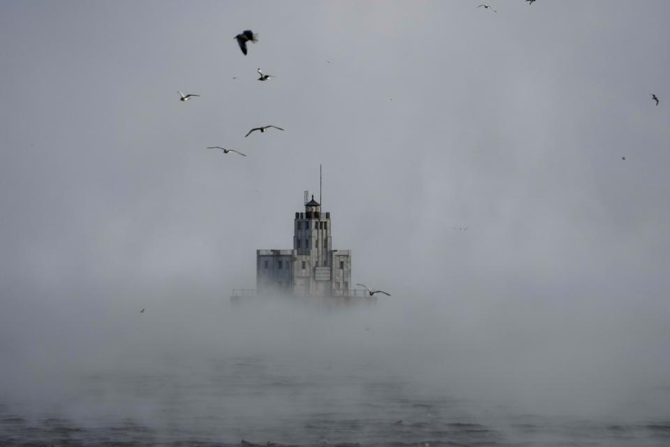 Steam rises off of Lake Michigan as morning temperatures remain below zero with heavy winds Friday, Dec. 23, 2022, in Milwaukee. Winter weather is blanketing the U.S. as a massive storm sent temperatures crashing and created whiteout conditions. (AP Photo/Morry Gash)