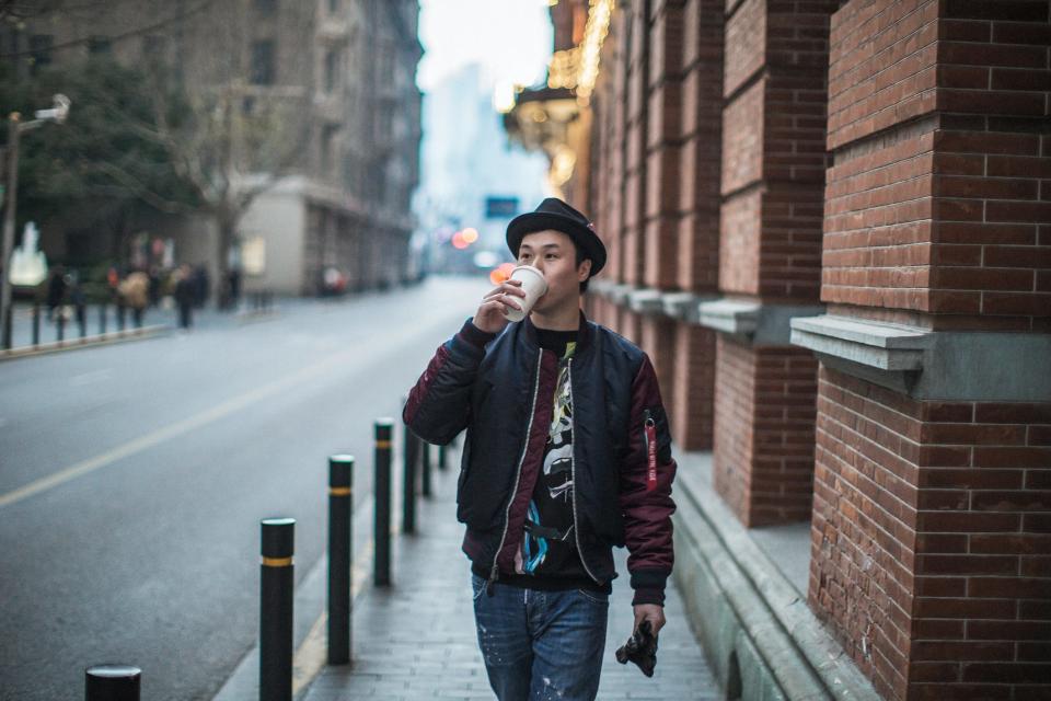 man walking and drinking coffee