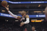Houston Rockets guard Russell Westbrook (0) lays the ball up during the first quarter of the team's NBA basketball game against the Sacramento Kings in Sacramento, Calif., Monday, Dec. 23, 2019. (AP Photo/Randall Benton)