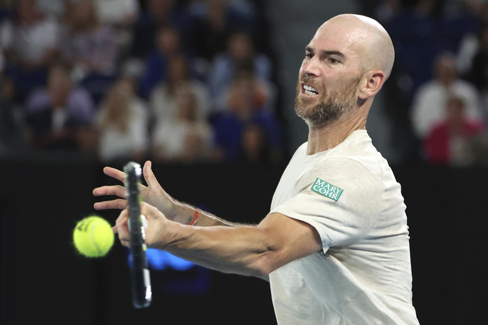 Adrian Mannarino of France plays a forehand return to Novak Djokovic of Serbia during their fourth round match at the Australian Open tennis championships at Melbourne Park, Melbourne, Australia, Sunday, Jan. 21, 2024. (AP Photo/Asanka Brendon Ratnayake)