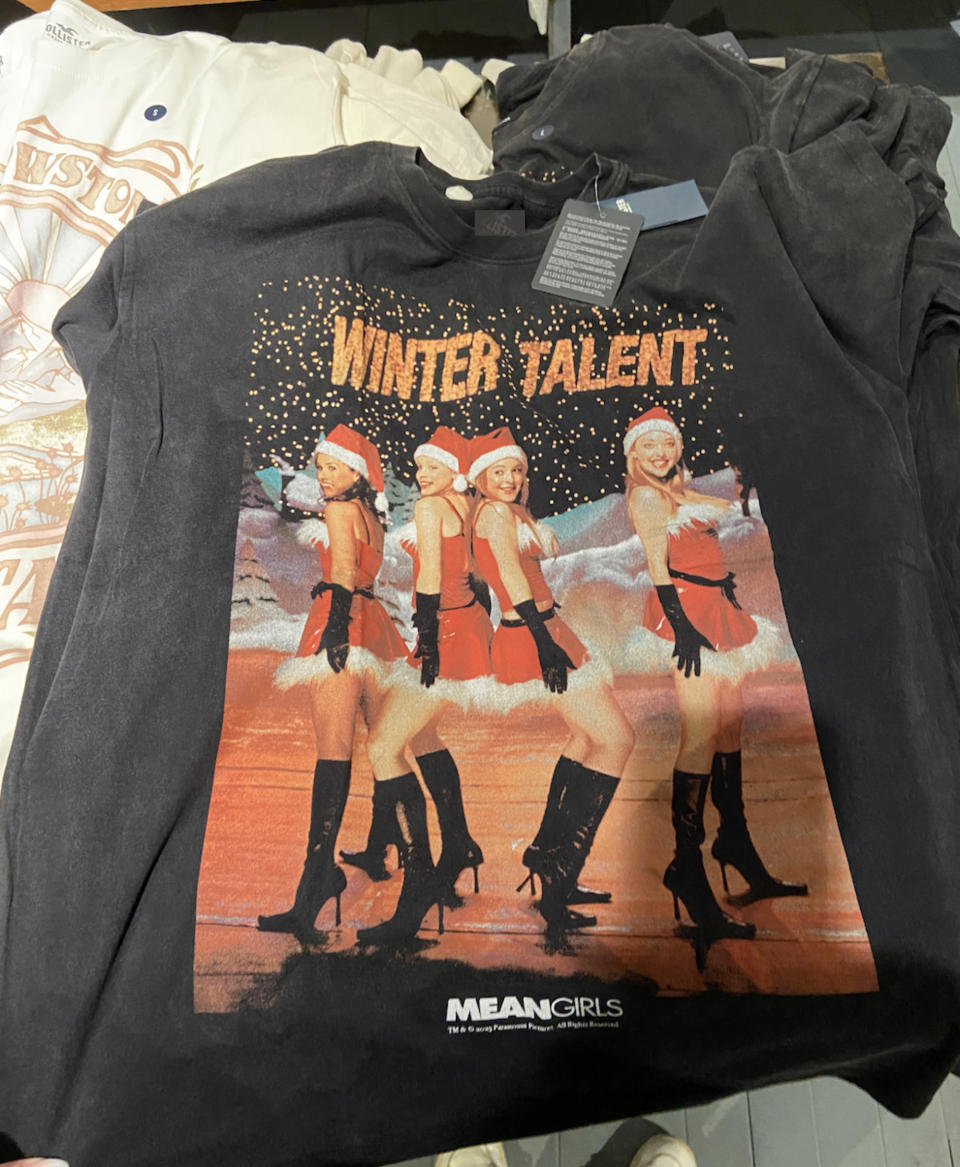 A t-shirt with the "Mean Girls" characters on it in their Christmas talent show Santa costumes