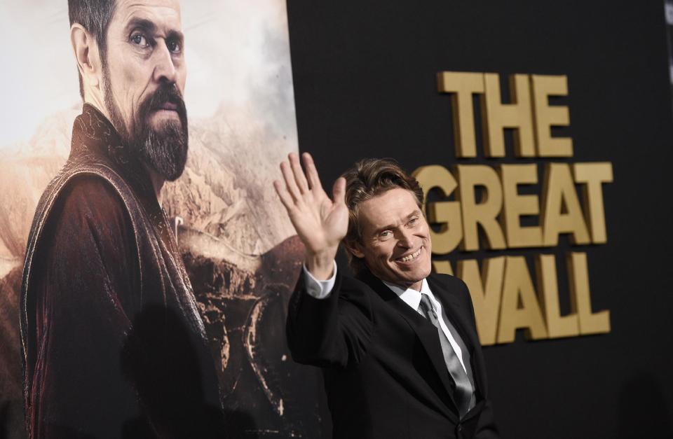 Willem Dafoe, a cast member in "The Great Wall," waves to photographers at the premiere of the film at the TCL Chinese Theatre on Wednesday, Feb. 15, 2017, in Los Angeles. (Photo by Chris Pizzello/Invision/AP)