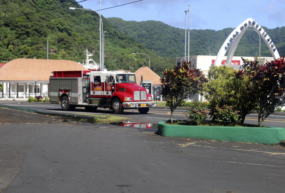 A firetruck tells people along the road, through a public address system (PA) to move to higher grounds following a tsunami warning for American Samoa in Pago Pago, Thursday, March 4, 2021. The Pacific Tsunami Warning Center cancelled a tsunami watch for Hawaii that was issued after a huge earthquake occurred in a remote area between New Zealand and Tonga. The agency previously cancelled a tsunami warning it had issued for American Samoa. (AP Photo/Fili Sagapolutele)