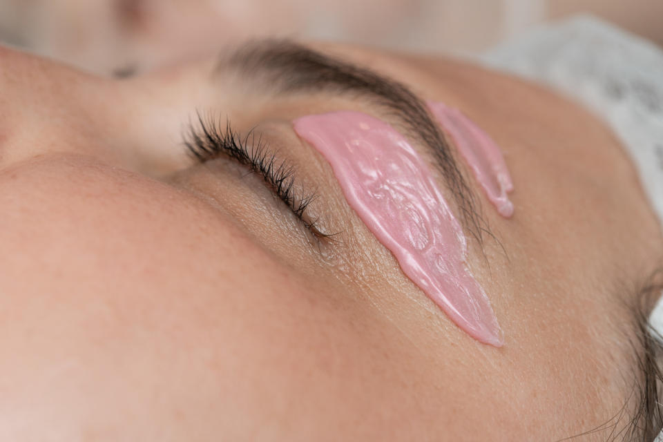 A woman getting her eyebrows waxed