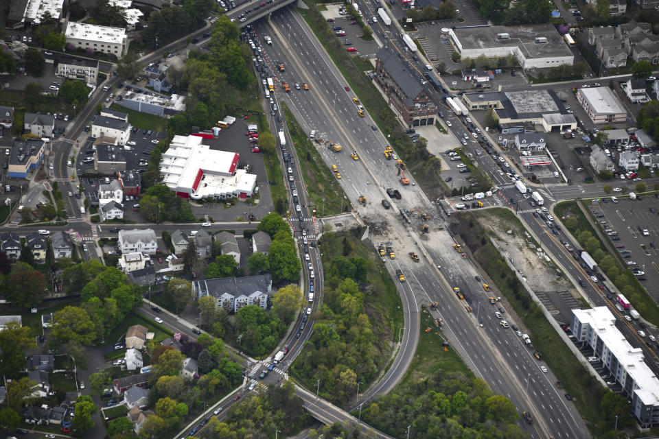 This aerial view looking south shows demolition crews working to finish removing the Fairfield Avenue bridge over Interstate 95, Saturday, May 4, 2024 in Norwalk, Conn. Crews are expected to finish removing the bridge by Sunday morning, and road repairs will be made. The tanker truck burst into flames under the overpass after colliding with two other vehicles Thursday. The cause remains under investigation. (Kevin Coughlin / All Island Aerial via AP)