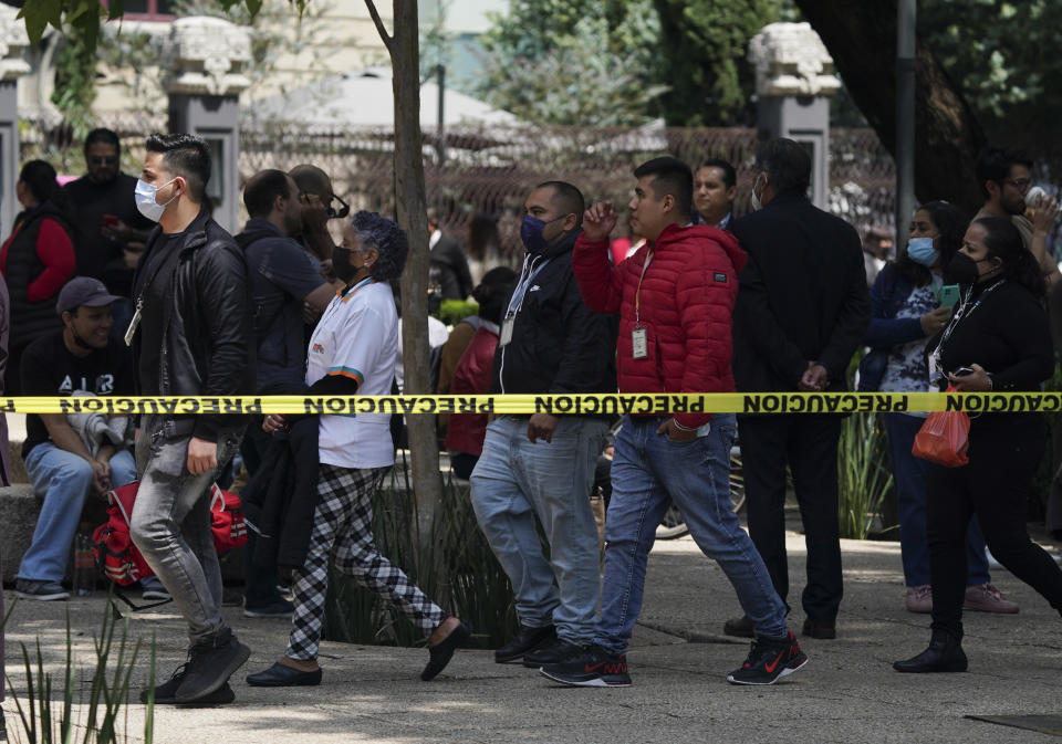 People walk to a meeting point on Paseo de la Reforma avenue as part of an earthquake simulation drill held to mark the anniversary of two past, deadly quakes in Mexico City, Monday, Sept. 19, 2022. Alarms for a real, 7.6 magnitude quake came less than an hour after this drill. (AP Photo/Fernando Llano)