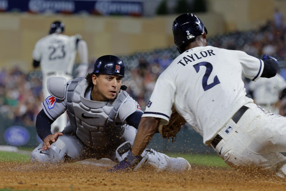 Cleveland Guardians catcher Bo Naylor, left, tags out Minnesota Twins' Michael A. Taylor who was trying to score from third base on a fielder's choice hit into by Royce Lewis in the eighth inning of a baseball game Monday, Aug. 28, 2023, in Minneapolis. (AP Photo/Bruce Kluckhohn)
